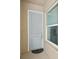 A stylish front door welcomes you, next to a large picture window allowing an interior view at 10530 Boardwalk Loop # 201, Lakewood Ranch, FL 34202