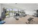 A well-equipped gym with modern exercise equipment and panoramic views of the lake at 10530 Boardwalk Loop # 201, Lakewood Ranch, FL 34202