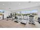 A well-equipped gym with modern exercise equipment and panoramic views of the lake at 10530 Boardwalk Loop # 201, Lakewood Ranch, FL 34202