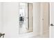 Hallway with a full length mirror revealing a look into the formal dining room at 10530 Boardwalk Loop # 201, Lakewood Ranch, FL 34202