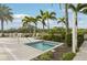 Relaxing hot tub surrounded by lush greenery and tropical palms, offering a private spa experience near the pool at 10530 Boardwalk Loop # 201, Lakewood Ranch, FL 34202