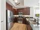 Well-lit kitchen features stainless steel appliances, dark cabinetry, and granite countertops for a sleek, modern feel at 10530 Boardwalk Loop # 201, Lakewood Ranch, FL 34202