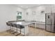 A modern kitchen area with sleek countertops, white cabinets, and stainless steel appliances at 10530 Boardwalk Loop # 201, Lakewood Ranch, FL 34202