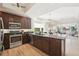 Modern kitchen with stainless steel appliances, granite counters, and wood flooring offers both style and functionality at 10530 Boardwalk Loop # 201, Lakewood Ranch, FL 34202