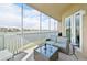 Enjoy serene lake views from this spacious screened lanai with comfortable outdoor seating at 10530 Boardwalk Loop # 201, Lakewood Ranch, FL 34202