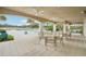 An inviting outdoor pool area with ample seating, umbrellas, and lush landscaping for relaxation at 10530 Boardwalk Loop # 201, Lakewood Ranch, FL 34202