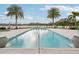 Beautifully maintained community pool with comfortable lounge chairs, offering a serene waterfront escape with scenic views at 10530 Boardwalk Loop # 201, Lakewood Ranch, FL 34202