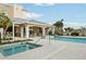 Inviting pool area with a hot tub, covered seating, and sun loungers, offering a complete outdoor leisure experience at 10530 Boardwalk Loop # 201, Lakewood Ranch, FL 34202