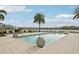 Resort-style pool with inviting lounge chairs and palm trees, offering a tranquil oasis with beautiful water views at 10530 Boardwalk Loop # 201, Lakewood Ranch, FL 34202
