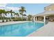 Inviting community pool with a pavilion, hot tub, and lounge area, set amidst tropical landscaping for resort-style living at 10530 Boardwalk Loop # 201, Lakewood Ranch, FL 34202