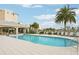Large community pool with a covered pavilion, sun loungers, and lush landscaping, perfect for relaxation and socializing at 10530 Boardwalk Loop # 201, Lakewood Ranch, FL 34202