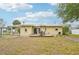 Spacious backyard with a cozy deck, perfect for grilling and outdoor entertaining near the home's sliding glass doors at 108 21St Ne St, Bradenton, FL 34208