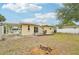 Expansive backyard features a well-maintained lawn, a covered carport, and a deck for outdoor living and entertainment at 108 21St Ne St, Bradenton, FL 34208