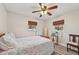Bright bedroom featuring two windows, ceiling fan, wood-look flooring, and a comfortable bed with a seashell-patterned comforter at 108 21St Ne St, Bradenton, FL 34208
