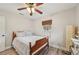 Bedroom with wood bed, ceiling fan, and neutral decor with light coming from the window at 108 21St Ne St, Bradenton, FL 34208