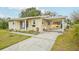This home features a carport and a side entry, complemented by a well-kept lawn and landscaping at 108 21St Ne St, Bradenton, FL 34208