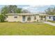 Charming single-story home featuring a well-maintained lawn, carport, and neutral-toned facade at 108 21St Ne St, Bradenton, FL 34208