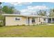 Attractive single-story home with manicured lawn and neutral siding, providing a welcoming curb appeal at 108 21St Ne St, Bradenton, FL 34208