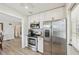 Modern kitchen featuring stainless steel appliances, white cabinets, and an adjacent dining area at 108 21St Ne St, Bradenton, FL 34208