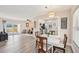 Open-concept living space featuring wood floors, dining area, living room, and sliding door access to the yard at 108 21St Ne St, Bradenton, FL 34208