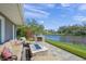 Relax on the back patio with a built in grill and fire pit while enjoying waterfront views at 1208 Angela Maria Rd, Sarasota, FL 34243
