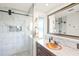 Luxurious bathroom featuring a glass-enclosed shower, a copper sink, and elegant tile work at 1208 Angela Maria Rd, Sarasota, FL 34243