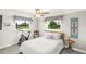 Cozy bedroom with an exercise bike, a comfortable bed, and bright windows at 1208 Angela Maria Rd, Sarasota, FL 34243
