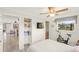 Comfortable bedroom featuring built-in shelving, a ceiling fan, and light-filled ambiance at 1208 Angela Maria Rd, Sarasota, FL 34243
