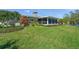 Charming home exterior with screened porch and lush landscaping at 1208 Angela Maria Rd, Sarasota, FL 34243