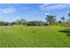 Exterior view of home with expansive lawn and mature trees at 1208 Angela Maria Rd, Sarasota, FL 34243