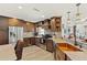 This stylish kitchen features rich wood cabinetry, stainless appliances, and a copper farmhouse sink at 1208 Angela Maria Rd, Sarasota, FL 34243