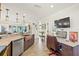 Modern kitchen features custom cabinets, stainless appliances, a breakfast bar, and a dedicated desk area at 1208 Angela Maria Rd, Sarasota, FL 34243