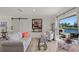 Living room with waterfront views features neutral tones, modern decor, and access to the outdoor patio at 1208 Angela Maria Rd, Sarasota, FL 34243