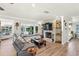 Inviting living area features a stone fireplace, wood floors, a window seat, and water views at 1208 Angela Maria Rd, Sarasota, FL 34243