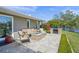 Paver patio features a fire pit and outdoor seating area overlooking the lake at 1208 Angela Maria Rd, Sarasota, FL 34243
