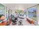 Bright sunroom with ample windows offering serene water views and comfortable seating at 1208 Angela Maria Rd, Sarasota, FL 34243