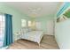 Bright bedroom with ceiling fan, two closets, and access to exterior balcony at 1429 Gulf N Dr, Bradenton Beach, FL 34217