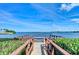 Charming wooden dock and railing provide a beautiful spot by the water with scenic surroundings at 1429 Gulf N Dr, Bradenton Beach, FL 34217
