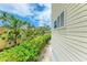 Exterior view showing well-maintained landscaping along the building's side at 1429 Gulf N Dr, Bradenton Beach, FL 34217