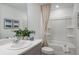 Bright bathroom featuring a tub with shower, a vanity with plenty of counter space, and stylish decor at 15124 Cuzcorro Ct, Nokomis, FL 34275