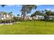 The community dog park features lush greenery, picnic tables, and fencing at 15124 Cuzcorro Ct, Nokomis, FL 34275