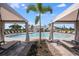 Beautiful community pool with cabanas, lounge seating, and lush landscaping, ideal for relaxation at 15124 Cuzcorro Ct, Nokomis, FL 34275