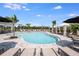 Resort-style pool with cabanas and lounge chairs offers a relaxing oasis for residents at 15124 Cuzcorro Ct, Nokomis, FL 34275