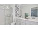 Beautiful bathroom featuring double sinks, decorative mirror, and glass shower at 15128 Cuzcorro Ct, Nokomis, FL 34275