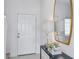 Inviting entryway with a decorative table and mirror that adds a touch of elegance at 15128 Cuzcorro Ct, Nokomis, FL 34275