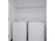 Convenient laundry area with modern washer and dryer, with a shelf above for storage at 15128 Cuzcorro Ct, Nokomis, FL 34275