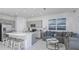 Open-concept living room with sleek kitchen, center island, and comfortable seating area at 15128 Cuzcorro Ct, Nokomis, FL 34275