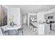 Open-concept living space with modern finishes, seamlessly connecting the kitchen, dining, and living areas at 15128 Cuzcorro Ct, Nokomis, FL 34275