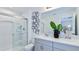 Modern bathroom with double sinks, quartz countertops, and glass-enclosed shower at 15132 Cuzcorro Ct, Nokomis, FL 34275