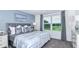 Cozy bedroom with a plush bed, stylish decor, and a large window offering natural light at 15132 Cuzcorro Ct, Nokomis, FL 34275